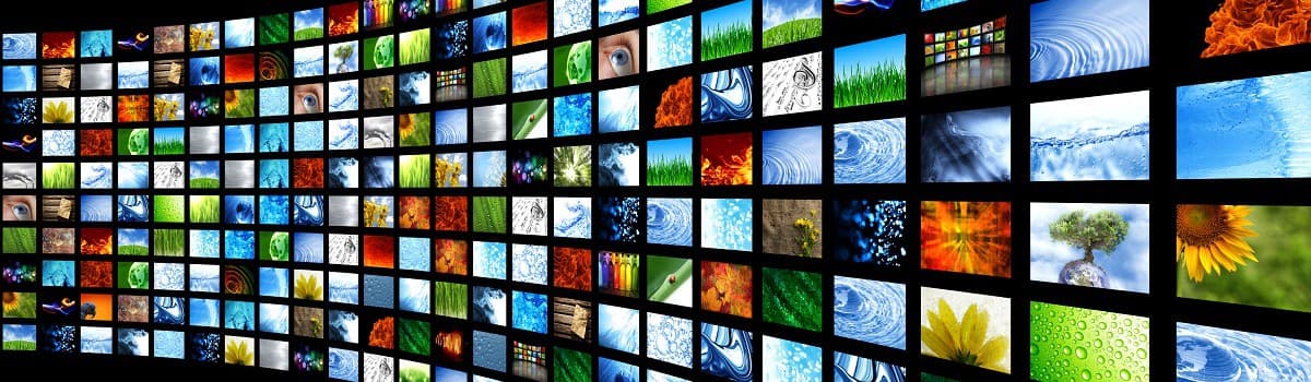 Grid of colorful video thumbnails with various images on a dark background.